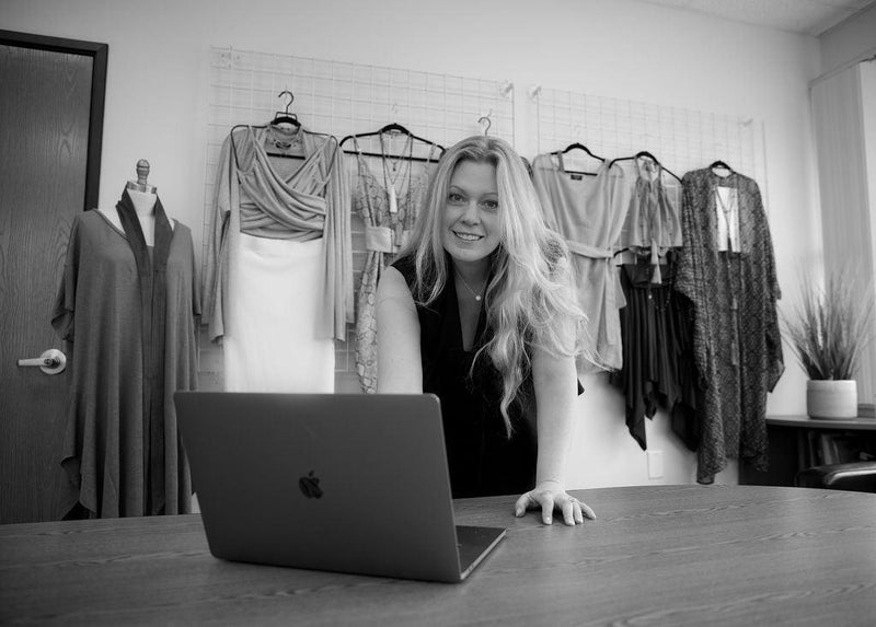 Designer Rebecca Grewal stands in front of the Revir summer 2021 collection