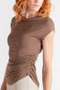 Brown top with a ruched design worn by a person on a white background