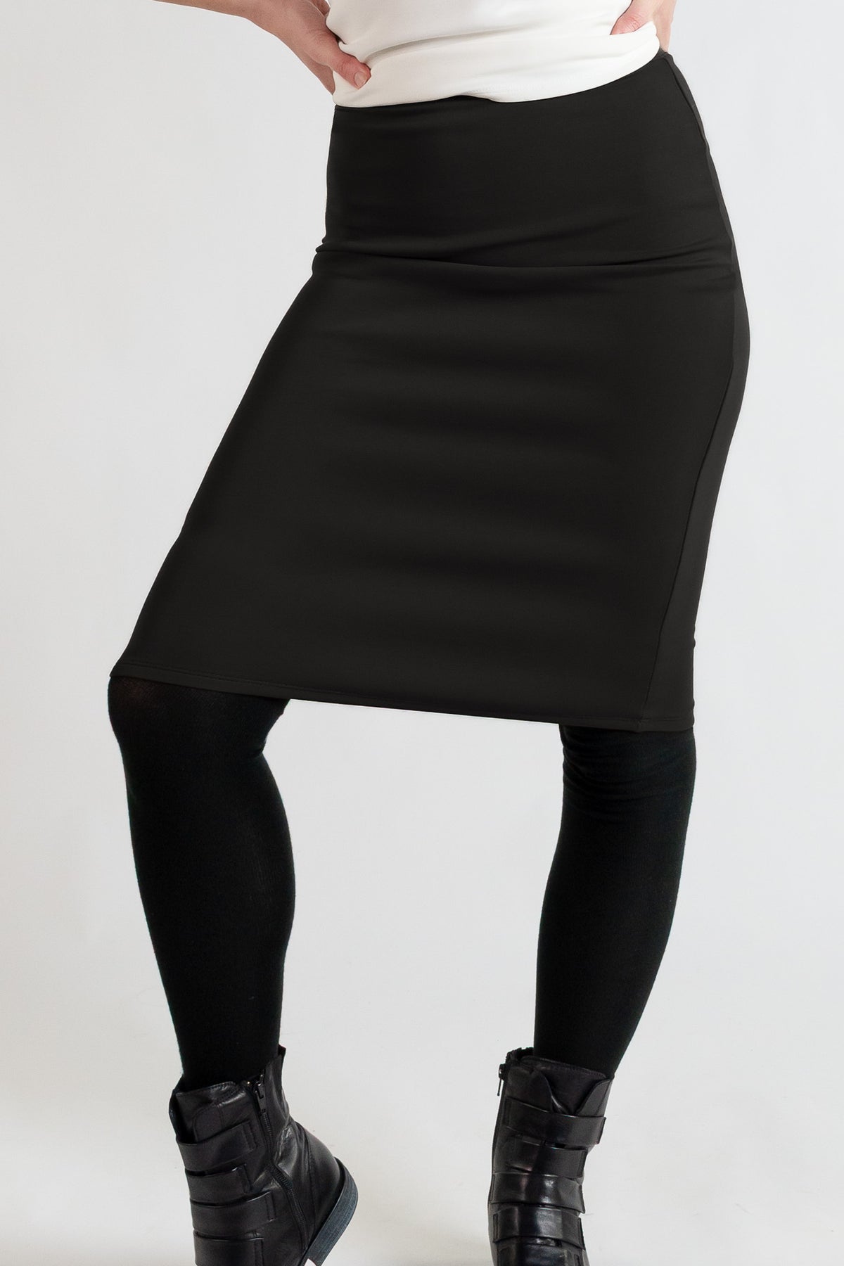 Black knee length pencil skirt on a white background