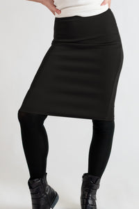 Black knee length pencil skirt on a white background