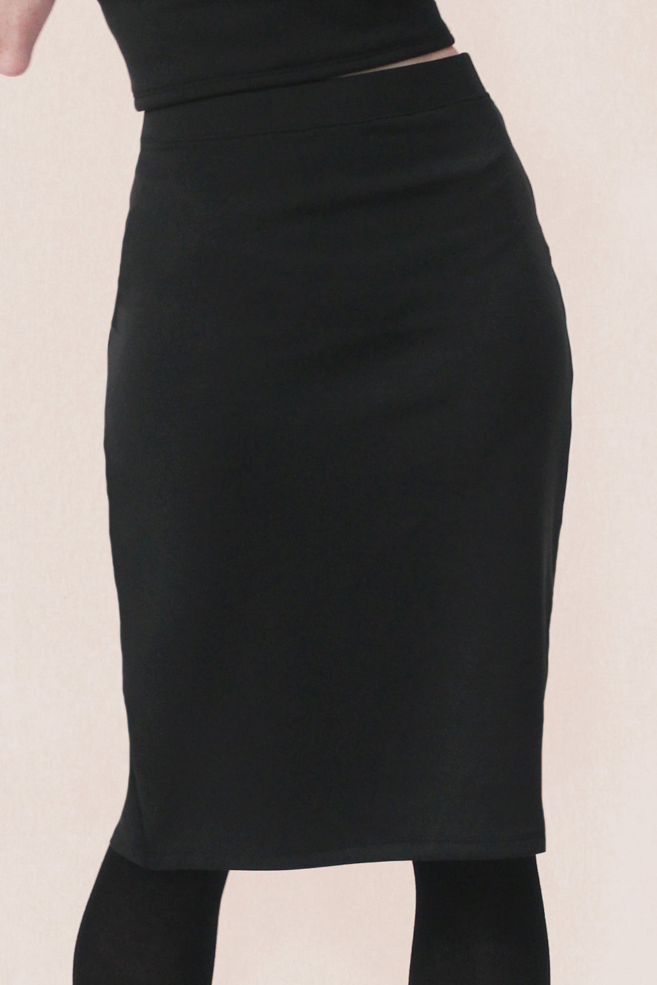Black knee length pencil skirt on a white background
