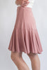 Pink skirt worn by a person on a white background