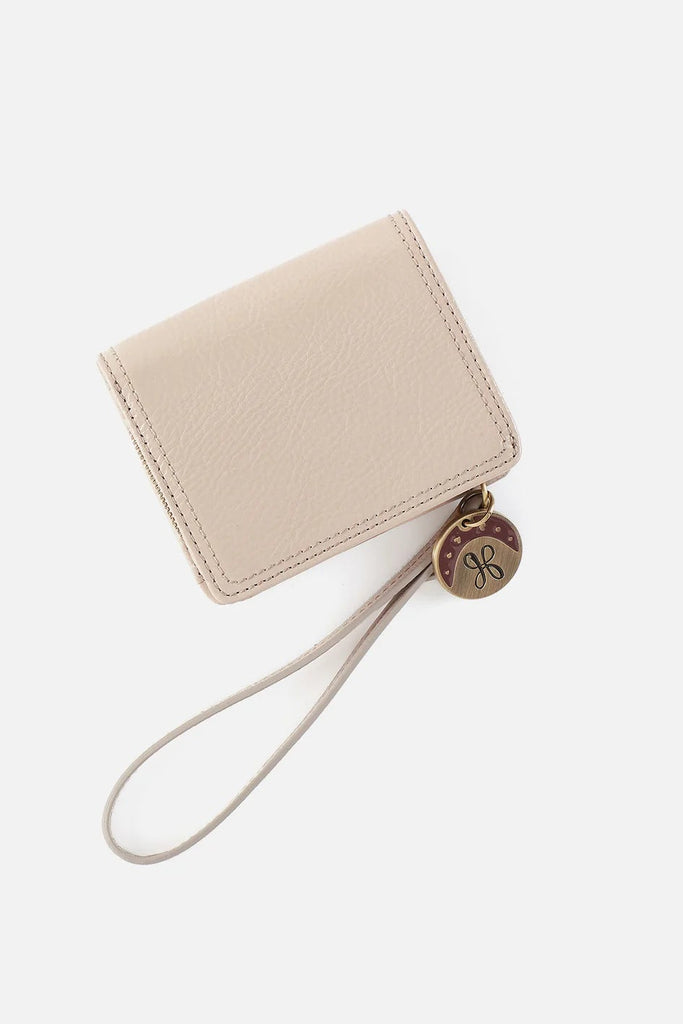 Beige wristlet with a strap on a white background
