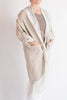 Person wearing a beige kimono-style garment on a plain background