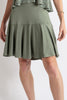 Woman wearing a green dress with a white background