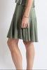Woman wearing a green dress with a white background