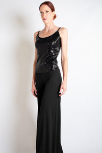 Woman wearing a black sequin cami, front full length view