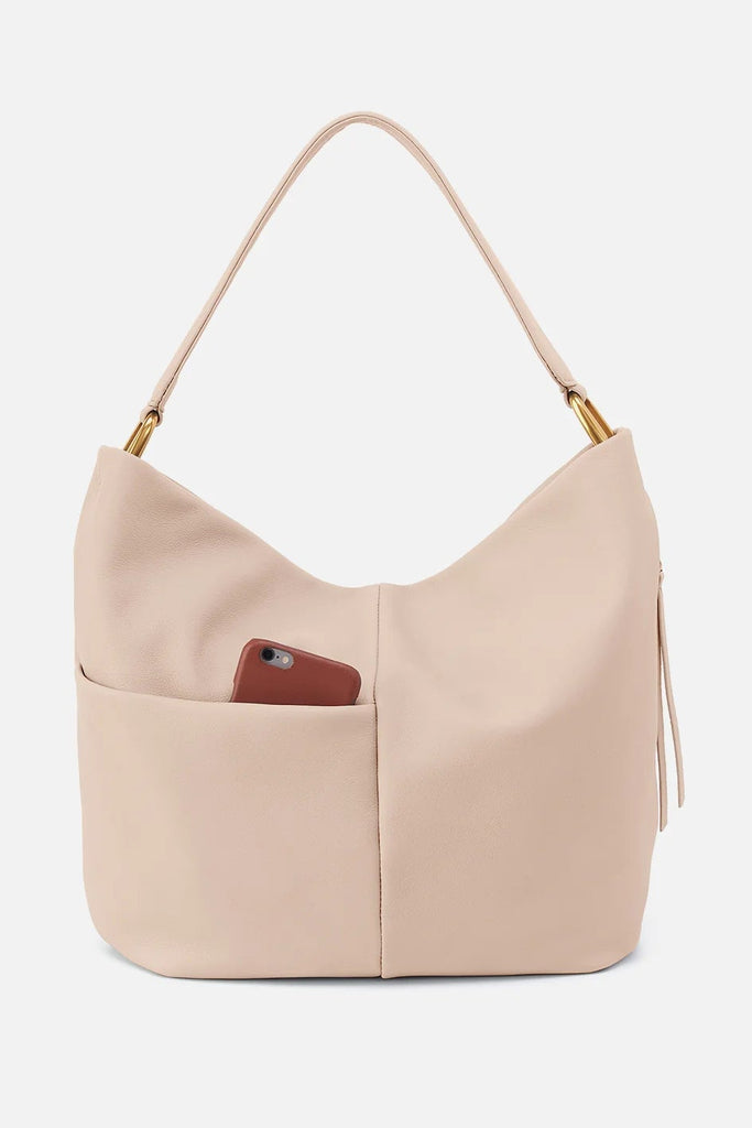 Beige handbag with a brown pocket on a light gray background