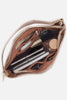 Open beige makeup bag with cosmetic items on a light gray background