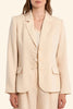 Woman wearing a beige suit on a beige background