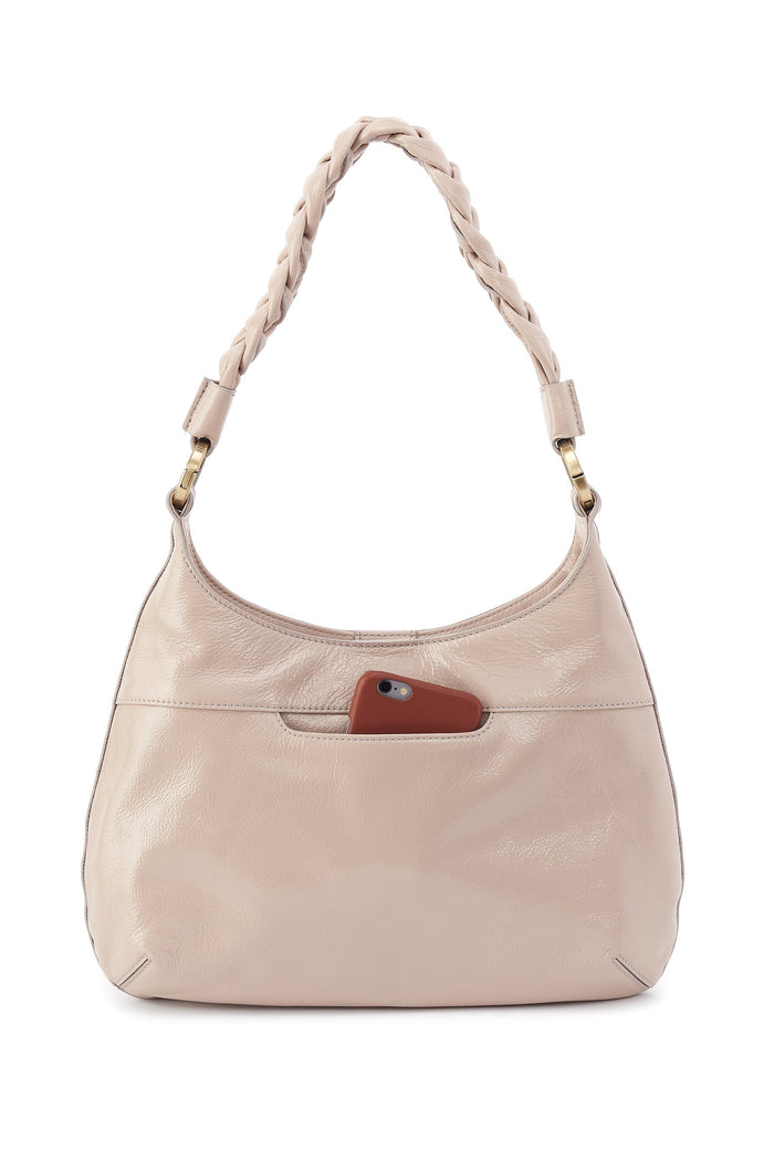 Beige handbag with a braided handle on a white background