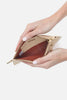 Hand holding a beige wallet with a visible brand logo on a white background
