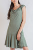 Woman wearing a green dress on a white background