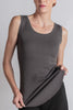 Model wearing the Hedy Tunic Tank, a ribbed tunic-length tank with curved hem and round neckline, styled for everyday layering