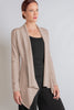 Woman wearing a long sleeve jacket in Dove. 