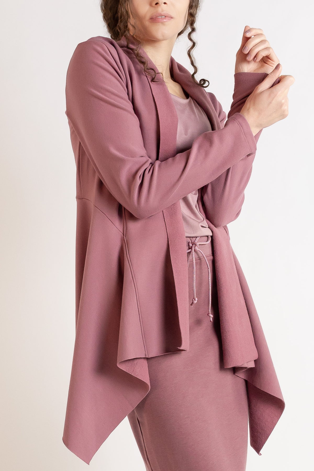Model wearing a mauve long-sleeve jacket.
