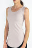 Model wearing the stone Hedy Tunic Tank, a ribbed tunic-length tank with curved hem and round neckline, styled for everyday layering